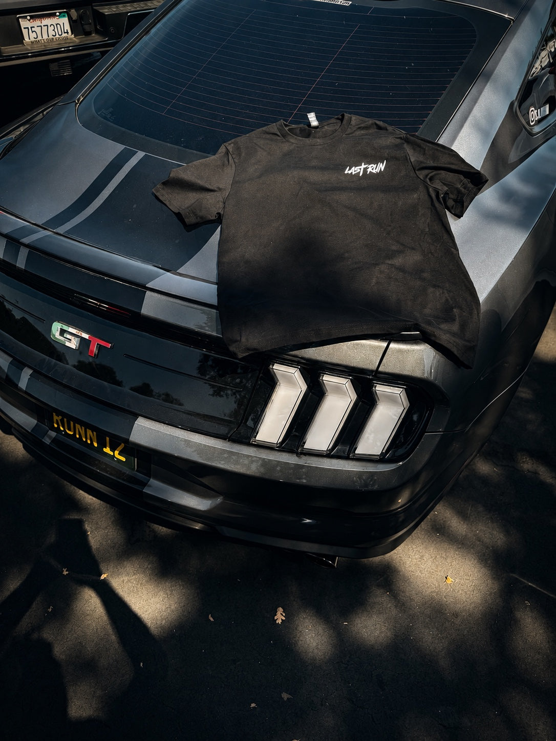 Front of Last Run black tee displayed on Mustang